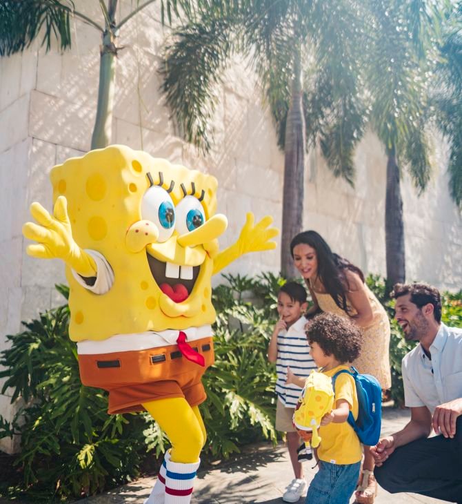 A Group Of Young Children Sitting Next To A Tree